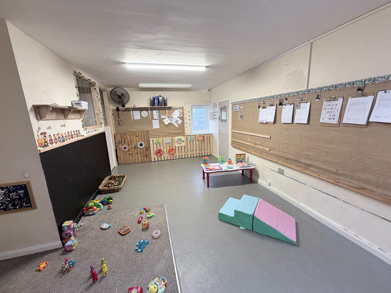 Staff supporting children with climbing and building play