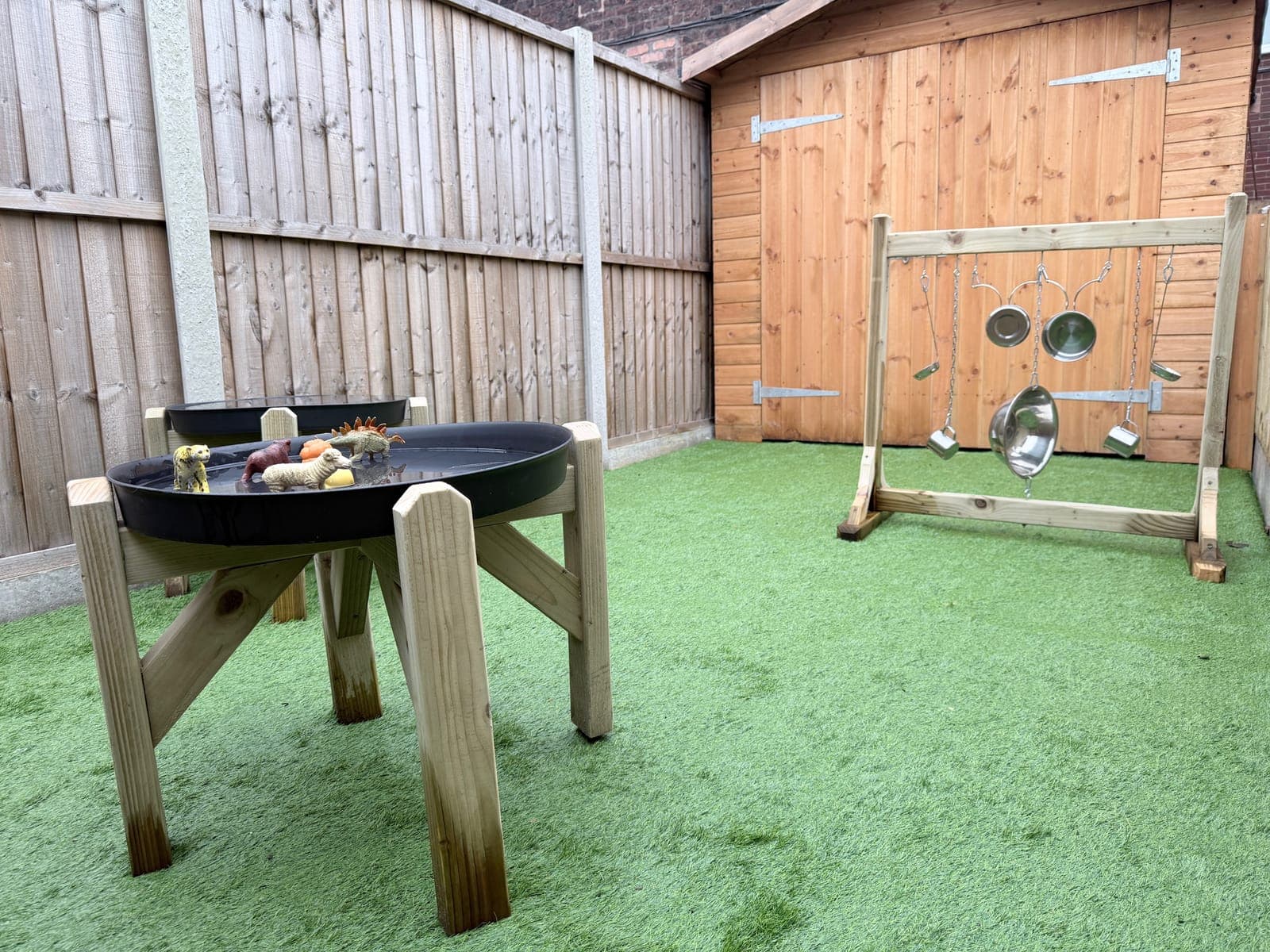 Children learning outdoors in the nursery garden area