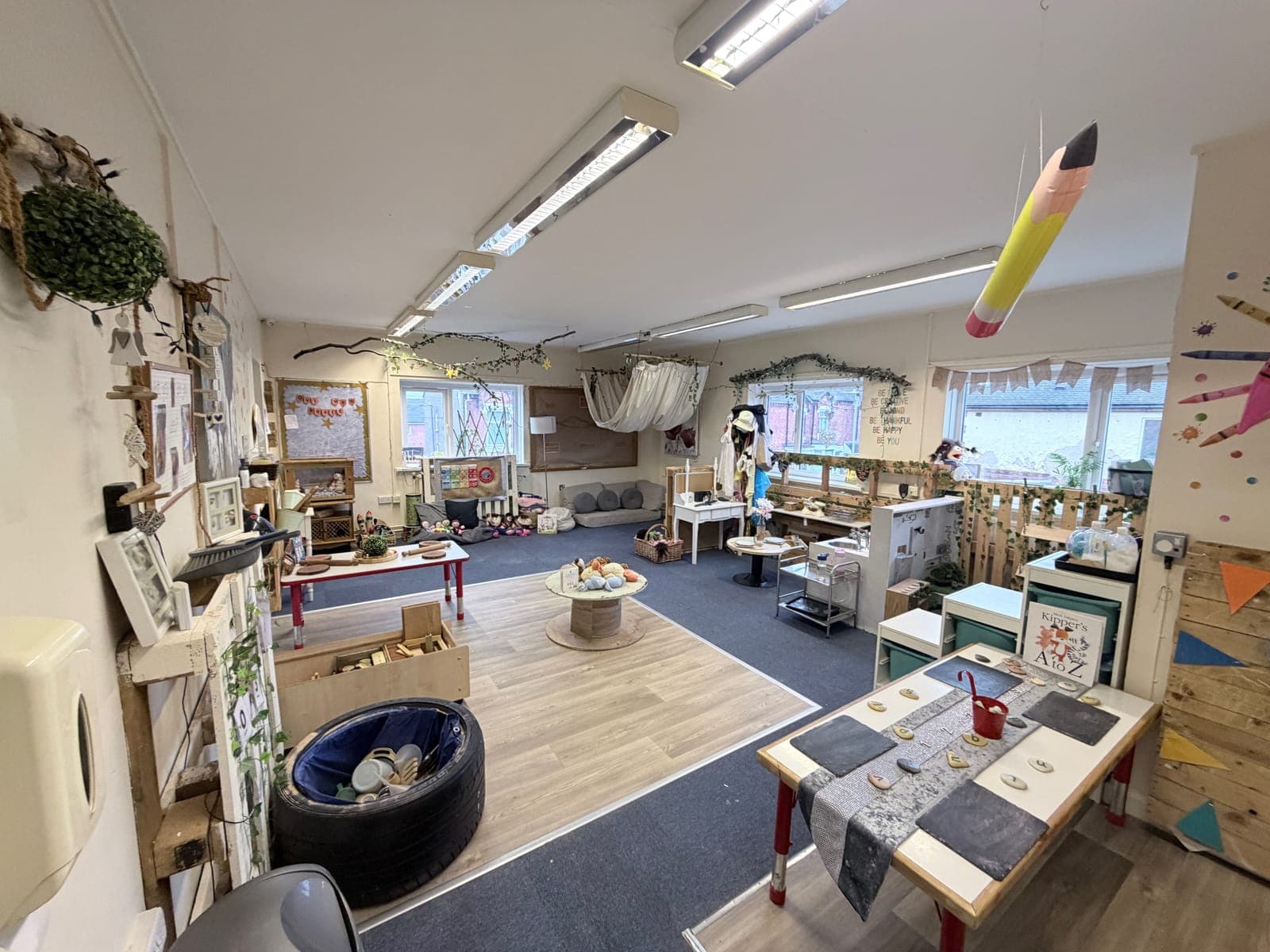 Children playing and reading at Busy Bugs Nursery